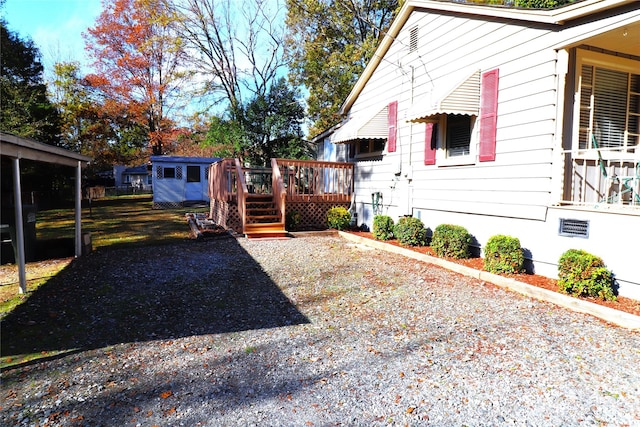 view of yard with an outdoor structure and a wooden deck