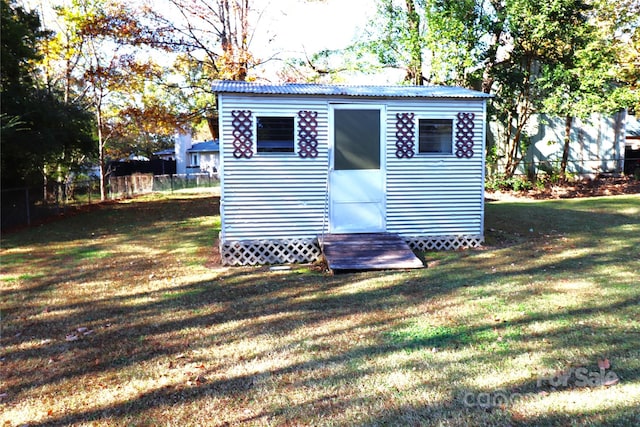 view of outbuilding with a yard