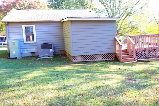 back of house with a yard and a deck