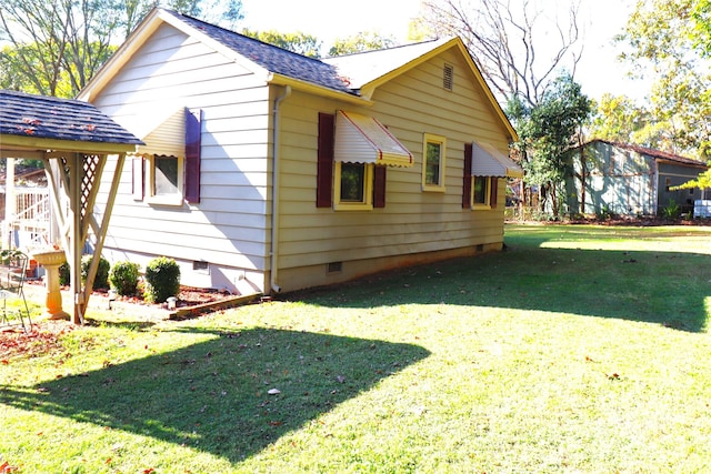 view of side of home with a yard