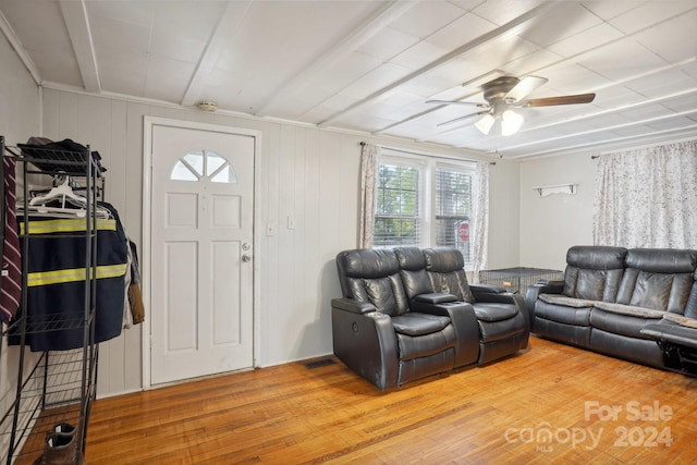 living room featuring hardwood / wood-style floors and ceiling fan