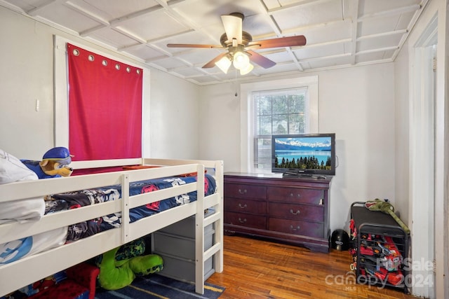 bedroom with ceiling fan and dark hardwood / wood-style flooring