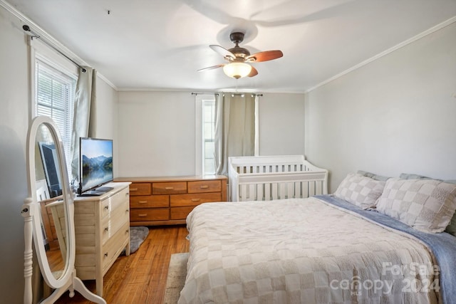 bedroom featuring ornamental molding, ceiling fan, and light hardwood / wood-style floors