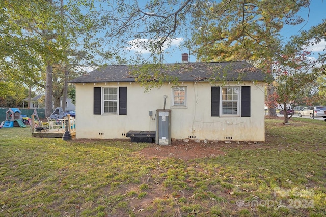 view of property exterior featuring a lawn