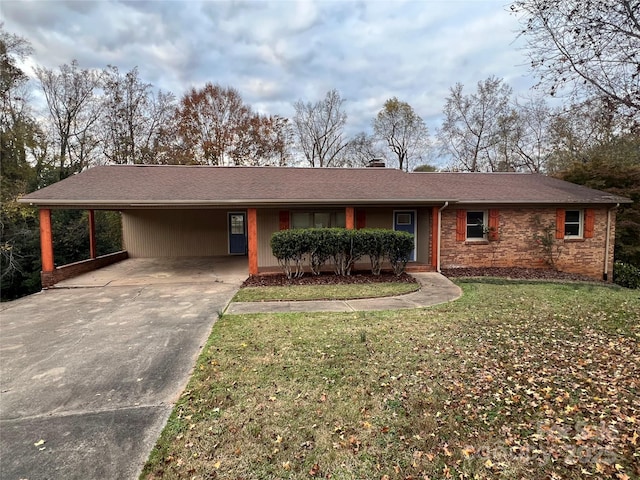 ranch-style home with a carport and a front lawn