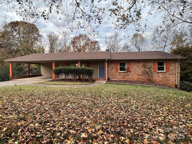 single story home featuring a carport and a front yard