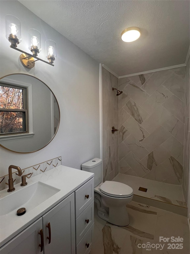 full bath featuring a textured ceiling, a tile shower, vanity, toilet, and marble finish floor