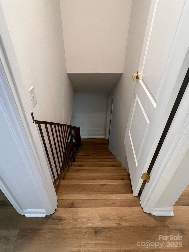 stairway featuring wood finished floors