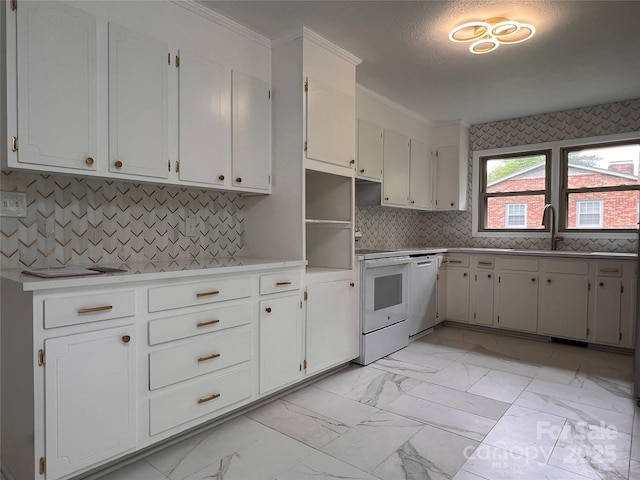 kitchen with a sink, light countertops, marble finish floor, ornamental molding, and white appliances