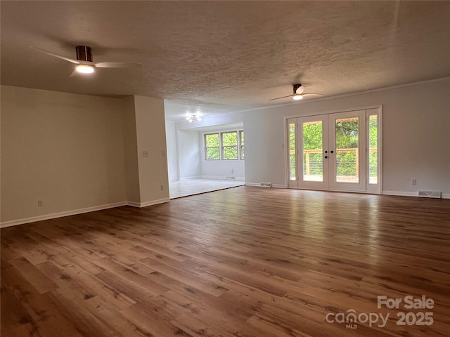 unfurnished room with a ceiling fan, baseboards, visible vents, and wood finished floors