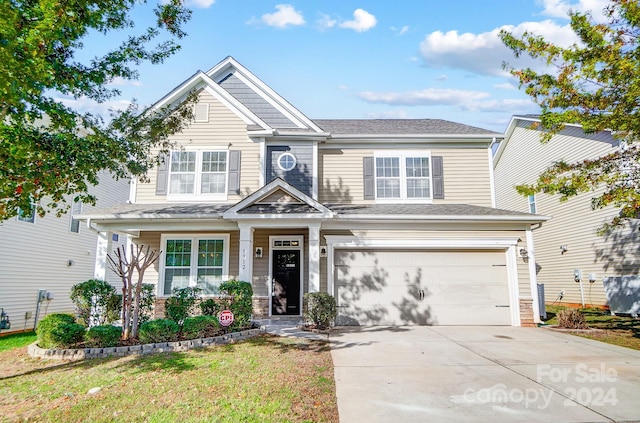 craftsman-style home with a garage and a front yard