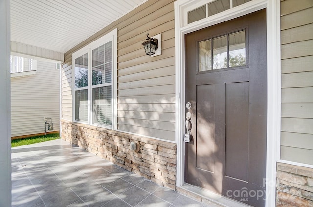 view of exterior entry featuring a porch