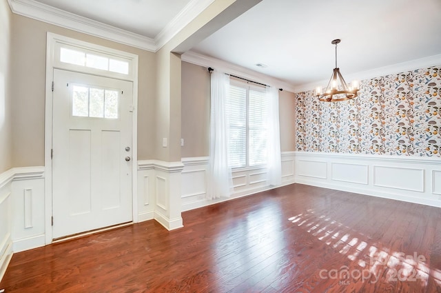 entryway with dark hardwood / wood-style flooring, a notable chandelier, a healthy amount of sunlight, and crown molding