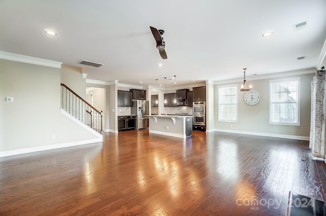 unfurnished living room with ornamental molding, ceiling fan, sink, and dark hardwood / wood-style floors