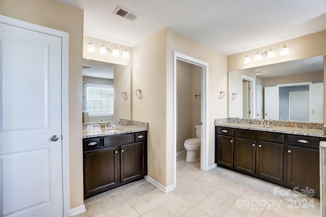 bathroom featuring vanity, tile patterned floors, and toilet