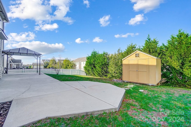 view of yard with a storage unit, a gazebo, and a patio area