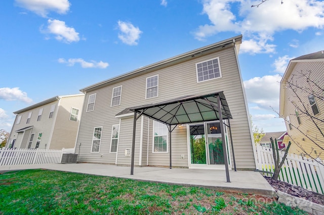 rear view of property with a patio area, central AC, and a gazebo