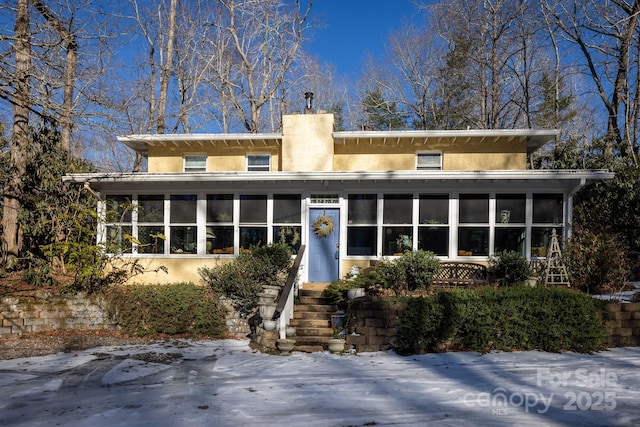 view of front of house featuring a sunroom