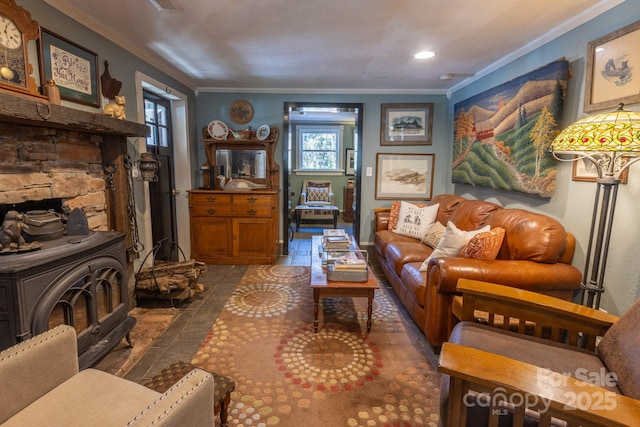 living room with dark tile patterned floors, crown molding, and a wood stove