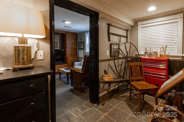 living area with ornamental molding