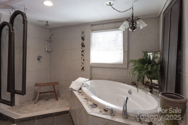 bathroom featuring tile walls, a notable chandelier, tile patterned floors, and shower with separate bathtub