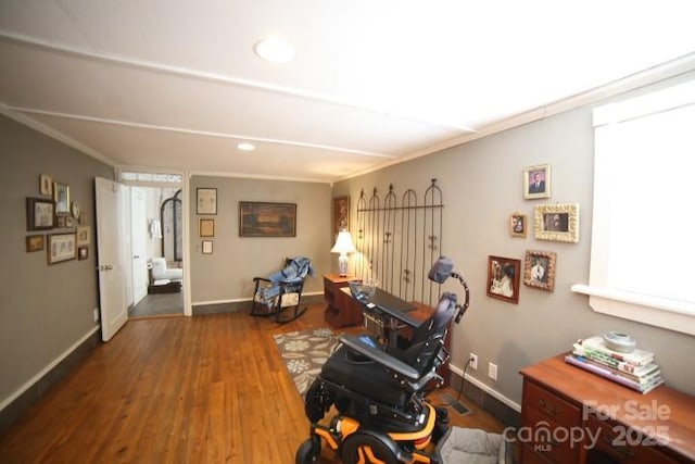 interior space featuring dark wood-type flooring and ornamental molding