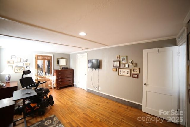 home office with hardwood / wood-style flooring and ornamental molding