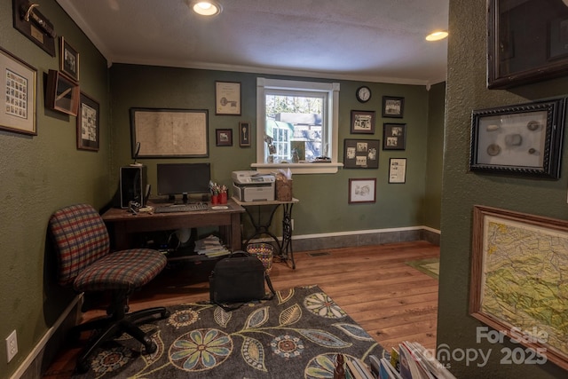 office space featuring crown molding and light hardwood / wood-style flooring