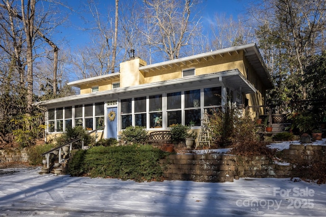 26 Kitazuma Rd, Black Mountain, NC 28711 - view of front of home featuring a sunroom, a chimney, stucco siding, and stairway