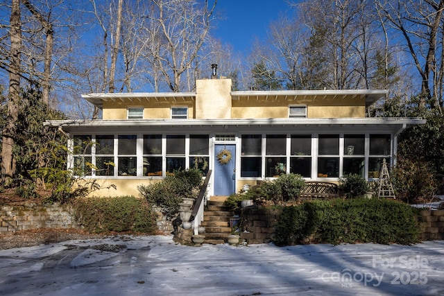 26 Kitazuma Rd, Black Mountain, NC 28711 - view of front facade with a sunroom, stucco siding, and a chimney