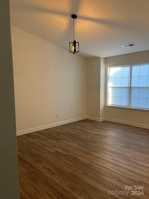 empty room with dark hardwood / wood-style floors