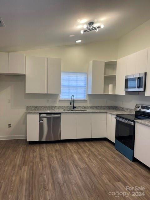 kitchen featuring appliances with stainless steel finishes, sink, and white cabinets