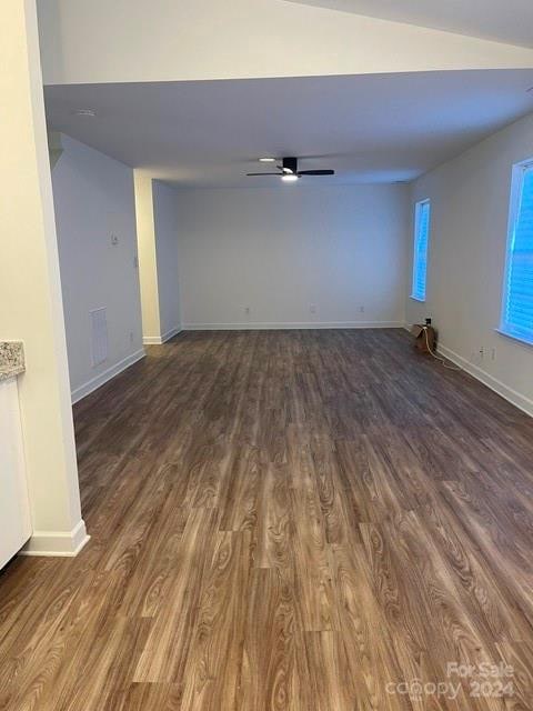 spare room featuring hardwood / wood-style flooring, ceiling fan, and vaulted ceiling