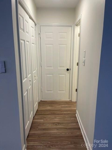 hallway with dark hardwood / wood-style flooring