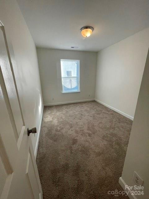 unfurnished room featuring carpet flooring