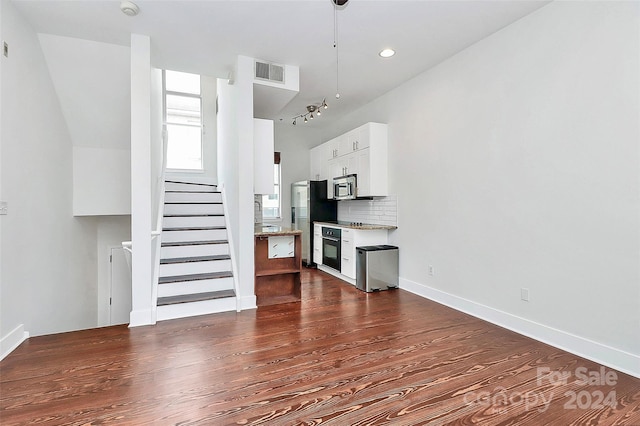 unfurnished living room with dark hardwood / wood-style floors