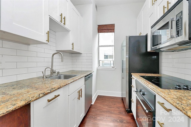 kitchen with dark wood-type flooring, white cabinets, sink, and stainless steel appliances