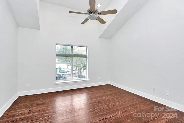 unfurnished room with ceiling fan, a high ceiling, and wood-type flooring