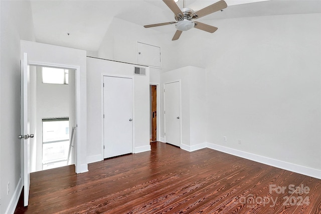 unfurnished bedroom featuring ceiling fan, dark hardwood / wood-style floors, and vaulted ceiling