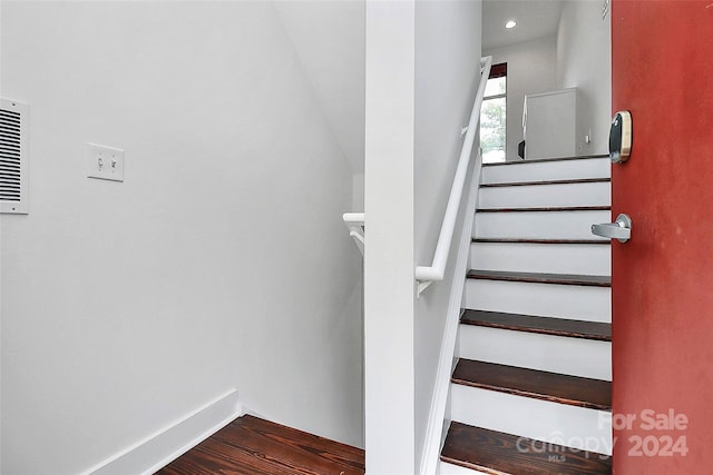 stairway featuring wood-type flooring