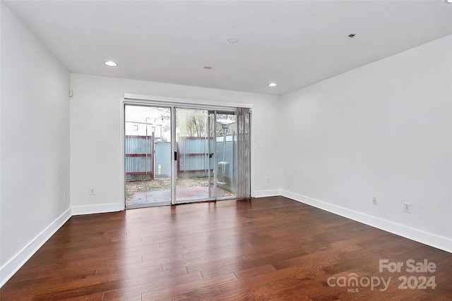 unfurnished room with dark hardwood / wood-style floors