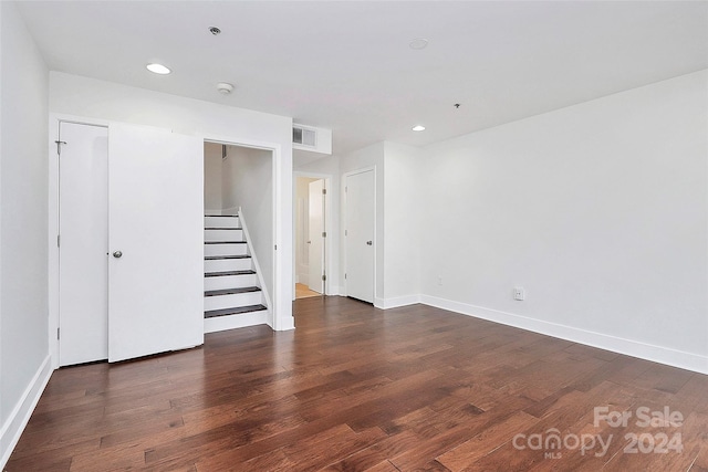 spare room with dark hardwood / wood-style flooring