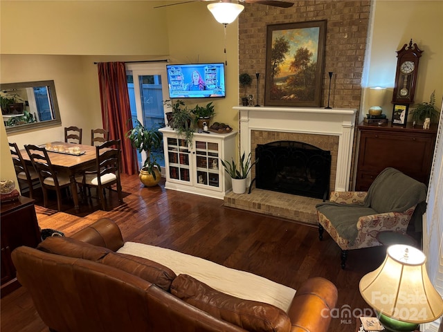 living room with a fireplace, hardwood / wood-style flooring, and ceiling fan