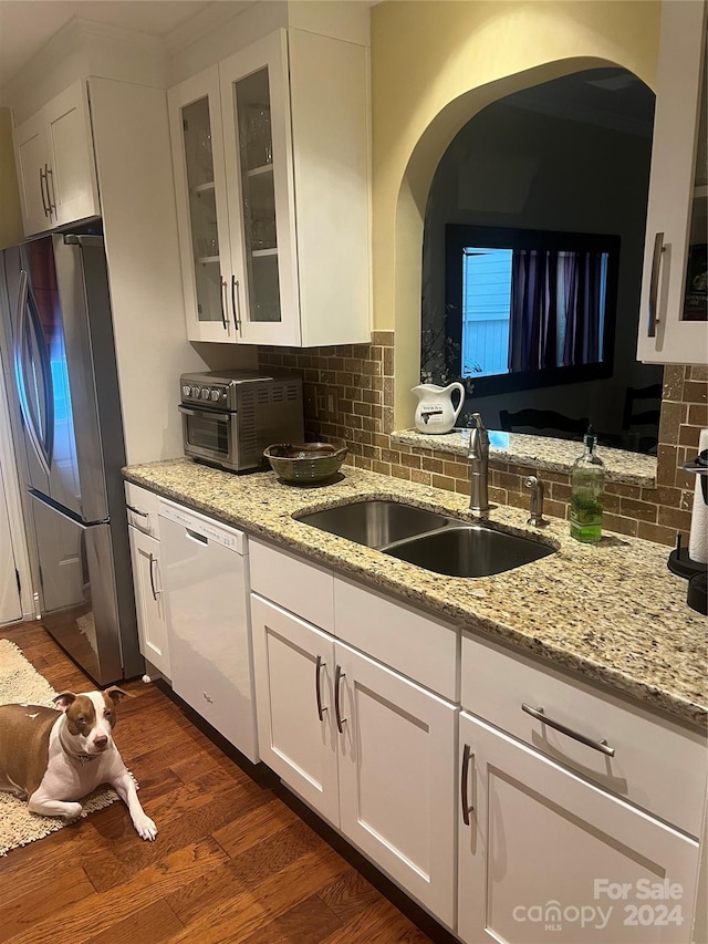 kitchen featuring white dishwasher, stainless steel fridge, white cabinetry, and dark wood-type flooring