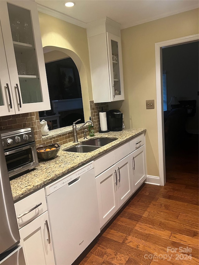 kitchen with white cabinetry, dark hardwood / wood-style flooring, decorative backsplash, sink, and dishwasher