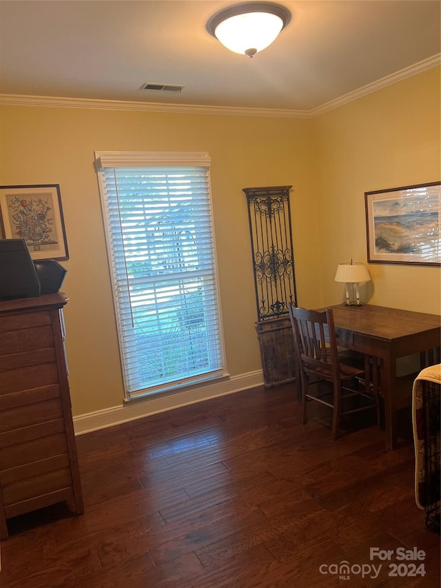 dining area featuring ornamental molding and dark wood-type flooring