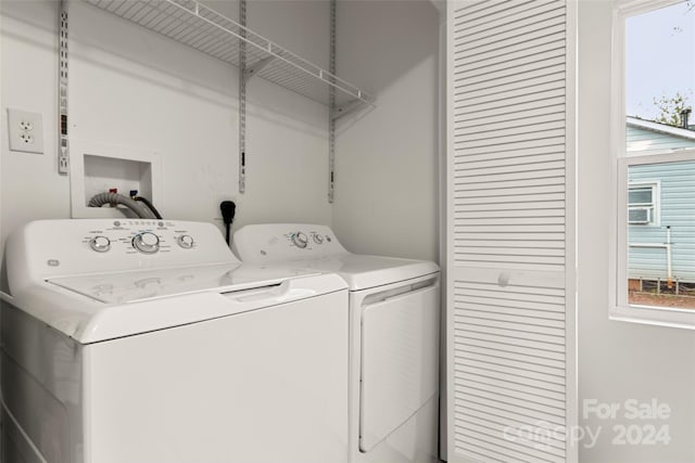 clothes washing area with plenty of natural light and washing machine and dryer