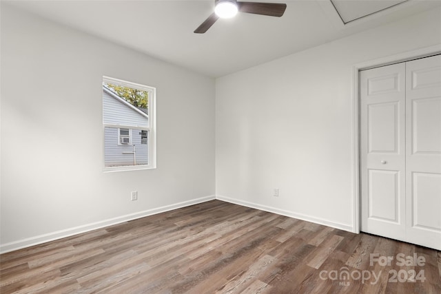 unfurnished bedroom with a closet, hardwood / wood-style floors, and ceiling fan