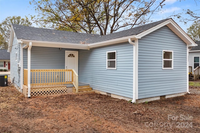 ranch-style home with cooling unit