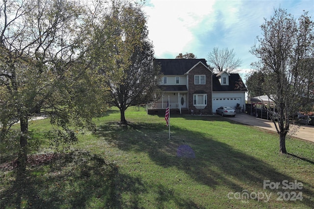 view of front facade featuring covered porch, a garage, and a front lawn